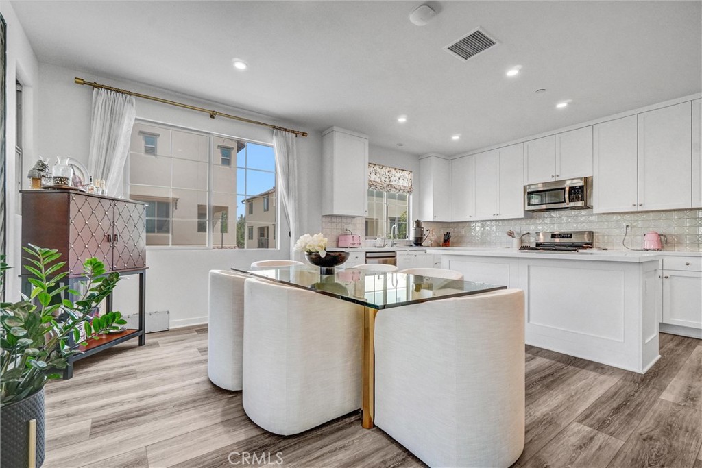This beautifully upgraded home is highlighted by soaring vaulted ceilings and luxury vinyl wood flooring throughout the open-concept living room, kitchen, and dining area—designed for both effortless entertaining and cozy everyday living.
The chef’s kitchen is a dream, sleek Della Terra quartz countertops, a modern tile backsplash, and a layout that flows perfectly into your main living spaces.
Upstairs, all bedrooms and stairs are upgraded with soft plush carpeting and premium padding, offering added comfort and warmth. Both bathrooms feature modern upgraded tile floors, creating a clean and fresh aesthetic throughout.
This smart home includes thoughtful enhancements such as:
Ring Doorbell
Energy-Efficient Low-E Glass Windows
Structured wiring with enhanced CAT-6 for fast internet
Google Nest Thermostat
FULLY PAID SOLAR PANELS to help minimize utility costs
The attached two-car garage is finished with epoxy flooring, installed level 2 charger, and bonus storage space. Additional stylish touches include plantation shutters and white roller shades on the sliding glass door that opens to your private balcony.
Enjoy walkable access to creatively landscaped paths, parks, pools, and playgrounds. Located within top-rated Irvine school districts, and just minutes from Irvine Spectrum, John Wayne Airport, and only a short drive to Laguna Beach.
You’ll also be near the highly anticipated Great Park expansion – including the future Great Park Live amphitheater, sports complexes, ice rink, botanical gardens, lakes, and The Canopy: an 11.5-acre lifestyle and retail destination set to open in early 2026.