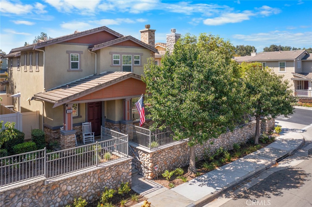 Welcome to 18066 Lemon Dr in beautiful Yorba Linda! This spacious 3-bedroom, 2.5-bathroom home offers 2,176 sq ft of living space and is located in a quiet, well-kept community. Built in 2004, this former model home features original finishes that have been lovingly maintained, offering a stylish and clean move-in ready space. The main floor features beautiful hardwood flooring throughout, a formal living room, family room with fireplace, open dining area, and a kitchen with granite countertops and ample cabinet space. Upstairs you’ll find a versatile loft, perfect for an office or play area, along with all three bedrooms. The primary suite includes a large walk-in closet and ensuite bath. Additional highlights include an upstairs laundry room, attached 2-car garage, low-maintenance patio, and low HOA dues. Conveniently located near award-winning schools, Main Street Historic District, and parks. Don’t miss your chance to make it your own!