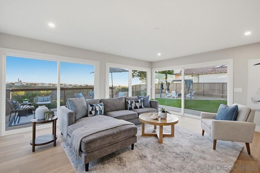 Perched along a quiet, coveted street in prestigious Bay Park, enjoy commanding views of the breathtaking canyon, University of San Diego, bay, ocean, and Point Loma from an elevated, oversized 1/4-acre estate. This exquisitely reimagined residence has been curated from top to bottom, blending refined craftsmanship with timeless sophistication. Every detail has been elevated, including a new roof, dual-pane windows and sliders, new air conditioning system, wide-plank flooring, an upgraded foundation, and a new sewer lateral. The sun-drenched, designer kitchen is a true centerpiece, showcasing custom cabinetry, quartz countertops, bespoke tilework, and sleek, high-end appliances, all flowing seamlessly into a dramatic, view-framed family room overlooking your backyard paradise. The outdoor grounds are equally refined, featuring professionally designed drought-tolerant landscaping, a newly constructed view deck, and an elegant pergola—ideal for private relaxation or upscale entertaining against a backdrop of sweeping coastal vistas. Both bathrooms have been transformed into spa-level retreats with custom designer tile, premium fixtures, and elevated finishes throughout.  A rare Bay Park offering, combining privacy, panoramic scenery, and modern luxury on an expansive lot, just moments from beaches, fine dining, and downtown San Diego.