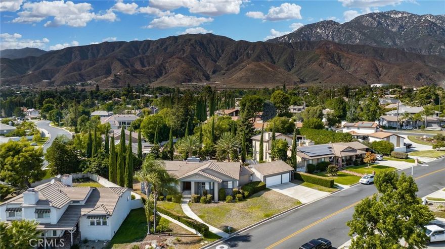 Discover this exclusive San Antonio Heights gem, a single-story home boasting 2,800 square feet of stylish living space on a sprawling 18,774 square-foot lot. The property offers breathtaking panoramic views of the mountains, making it the perfect setting for an ADU addition—ideal for those seeking guest quarters or providing a place for parents to live with privacy while at the same time, being able to participate in family living and staying connected.



Step through the double-door entry into a home adorned with exquisite hardwood flooring throughout. The formal living room seamlessly flows into a generously sized formal dining room, featuring coffered ceilings that create a space well suited for entertaining friends and family—perfect with the holidays approaching. The dining room provides direct access to the kitchen, a true chef's delight. This expansive kitchen opens to the family room and includes a breakfast counter bar, a center island, an abundance of cabinetry, and a cozy breakfast nook. The earthy wood beam ceilings and the warmth of the stone fireplace with a raised hearth in the family room make it an inviting space for relaxation.



The home features three bedrooms, including a romantic primary en suite. Unwind in the luxurious soaking tub or enjoy the shower. The additional two bedrooms are well-sized, with a secondary bath offering double sinks and a tub-over-shower.



The backyard is your private oasis, accessible through sliding glass doors in the family room. A covered view deck provides a perfect vantage point to soak in the stunning mountain views. The expansive backyard also includes a pool and spa, with ample land available for building an ADU or realizing your own dreamy outdoor space. An abundance of fruit trees will amaze you.



Additional amenities include a three-car attached garage, surround sound in the family, living, and outdoor spaces, plantation shutters, and so much more. This home combines simplicity with sophistication, offering a warm and inviting atmosphere with a unique artistic flair.



You will absolutely love coming home to this beautiful property! Make it yours today!
