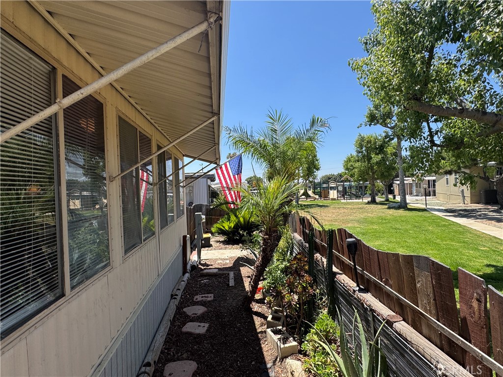 Cozy mobile home in quiet, nice community. Amenities right outside your yard include; playground, grassy common area, pool, and 2 jacuzzis. Home is close to office and club house. Privacy fence gives you seclusion to enjoy the luscious landscaping. 2 separate backyard areas. Lovely, soothing fountain surrounded by giant elephant ear plants and gorgeous hibiscus and other flowers. Very large covered porch and spacious patio perfect for grilling and entertaining. Huge driveway can accommodate 3 large vehicles. Newer roof, new flooring in bedrooms and hallway. Master has 2 very ample closets with new mirrored doors. Mirrored doors in large hallway closet as well. Large front windows give a lovely view of the park and are perfect for indoor plants to thrive. Wonderful, quiet neighbors on each side. Excellent school district at Bonita Unified. Come see this home to appreciate!