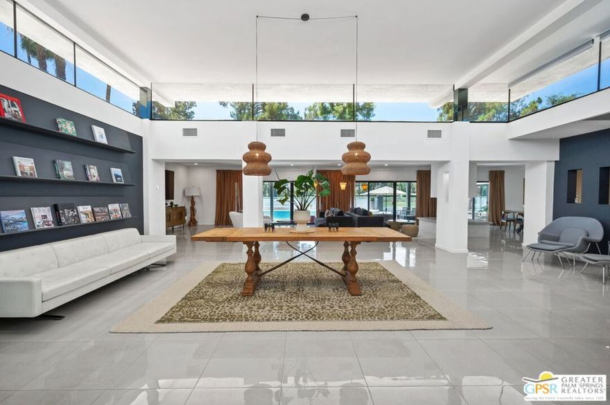 Welcome to 71183 Country Club Drive, a true mid-century gem located in the prestigious Thunderbird Country Club neighborhood of Rancho Mirage. This custom-designed home, built in 1964, exudes timeless mid-century elegance while adding a touch of modern sophistication to this desert retreat. Enter through a private gated motor court featuring a distinctive V-shaped support. The open living areas beautifully connect indoor and outdoor spaces, filled with natural light from the floor-to-ceiling glass and clerestory windows. The designer furnishings complement the architecture, creating a harmonious ambiance throughout the home. Restored and fully updated, this residence spans 4,874 square feet and includes four bedrooms, including a luxurious en-suite primary bedroom, and four stylish bathrooms. It is perfect for multi-generational living or hosting guests. Dine alfresco under the covered patio as you enjoy stunning sunsets over the fairway, surrounded by the breathtaking desert mountains. Key features of this property include two fireplaces, two walk-in closets, a chef's kitchen, a den, skylights throughout, a drought-resistant landscape, a two-car garage, a swimming pool, a spa, a barbecue area, engineered lawns, and much more. This desert retreat offers the finest in Southern California living.