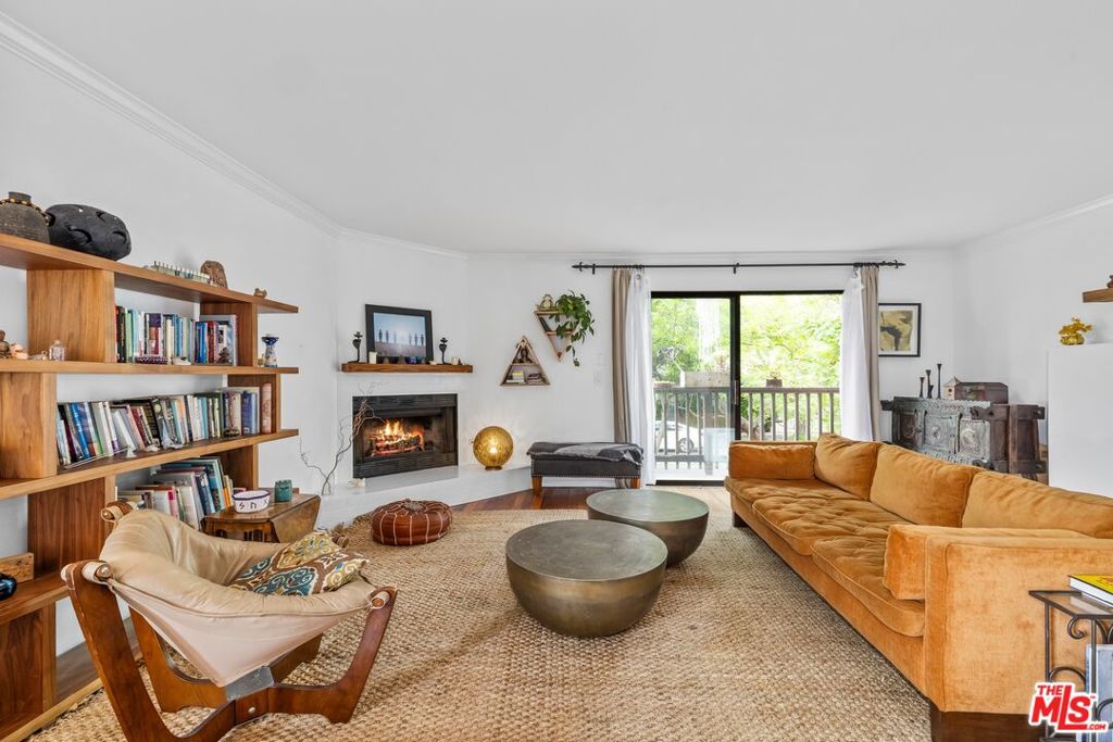 Beautiful townhome close to the beach and Venice Canals! This beautifully designed two-story townhouse offers 2 bedrooms, 2.5 baths, and an open floor plan that seamlessly connects the kitchen, dining, and living areasperfect for entertaining and everyday comfort. Rich Kempas hardwood floors run throughout the home, complemented by two cozy wood-burning fireplaces that add warmth and character.The main level features a convenient half bath with vintage tile and upgraded Kohler fixtures, as well as a side-by-side washer and dryer for added ease. As a front-facing, west-facing home, it enjoys abundant natural light throughout the day and refreshing ocean breezes. Upstairs, the oversized primary suite feels like a private retreat, complete with a wood-burning fireplace, walk-in closet, an additional large closet, and a private terrace where you can relax while taking in swaying palm trees and serene sunsets. The luxurious en-suite bathroom includes a spacious soaking/spa tub and a separate shower. The second bedroom also offers generous closet space and a private en-suite bath featuring custom, beach-inspired tile work. Additional highlights include two dedicated parking spaces, four guest parking spots, and extra storage. This townhouse blends comfort, character, and coastal charm in an ideal location.