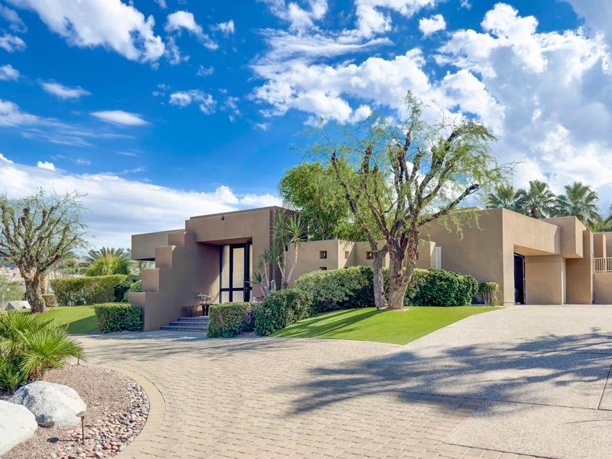 Discover the perfect blend of contemporary design, privacy, and luxury at this distinctive custom home in The Highlands--one of the most coveted enclaves within Ironwood Country Club. With over 4,450 square feet of refined living space on a premium elevated half-acre lot, this residence captures beautiful mountain views while offering an effortless indoor-outdoor lifestyle. Thoughtfully designed for both comfort and style, the home features three bedrooms plus a den and four-and-a-half baths, including two spacious primary suites. Walls of glass and high ceilings flood the interiors with natural light, highlighting the home's architectural sophistication. The expansive great room features a step-down wet bar, limestone flooring, and a sleek fireplace--perfect for entertaining. A gourmet kitchen with white oak cabinetry, granite countertops, a large island, and professional-grade Sub-Zero, Bosch, and KitchenAid appliances will delight any chef. Both primary suites are true retreats, each with seamless corner windows framing dramatic views, luxurious baths with bidet toilets, and generous walk-in closets. One suite features a fireplace, a spa-style tub, marble shower & countertops, and dual vanities, while the other offers its own private sanctuary. Outdoors, you'll find spaces designed for relaxation and entertaining--from the gated entry courtyard  to the landscaped backyard with artificial turf, built-in BBQ, and Pebble Tec pool and spa framed by stacked stone. The three-car garage with epoxy flooring, owned 60-panel solar system with  batteries that power the home for 24 hours, four HVAC zones, and two new water heaters reflect the home's thoughtful attention to comfort and efficiency. Located in the prestigious Ironwood Country Club--one of Palm Desert's premier private communities--residents enjoy access to two championship golf courses, world-class tennis and pickleball facilities, a state-of-the-art fitness and wellness center, and both fine and casual dining options. An active social calendar and stunning desert setting make Ironwood an exceptional place to call home. This extraordinary residence embodies desert contemporary living at its finest--private, refined, and perfectly positioned for those who value design, quality, and serenity.