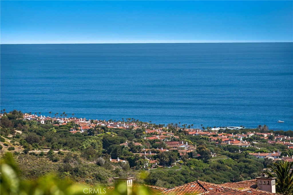 Indulge in elegant coastal living at this opulent ocean-view with 18 Sail Vista in Newport Coast. This once in a lifetime custom estate sits at the top of the ultra-exclusive Pelican Crest community on a premier wraparound lot which features the best unobstructed ocean views. It opens a world of possibilities that spans Catalina Island, the Newport Harbor, Skyline and pristine golf greens. The breathtaking shoreline views with year round sunsets and Catalina rest in the back drop. Every inch of this architect-driven, open-concept home has been carefully curated with structure and entertainment in mind. Radiating an encapsulates luxury living at every turn. This meticulously custom built home offering a rare and inviting opportunity intentional, intimate environment where nature's beauty converges with architectural artistry, manifesting as the ultimate sanctuary for harmonious living. Crowning a coastal hill at the end of a private cul-de-sac. Step inside to discover a gourmet kitchen, adorned with marble countertops. Everything fusions with the fresh ocean breeze. The living room draws friends and family together, complete with custom built-ins, and an open floor plan that seamlessly connects indoor and outdoor areas which is perfect for entertaining. Outdoor pool is not only hosting stylish celebrations and delighting esteemed guests, but also for peaceful, present living in a serene and sunset-drenched environment. The upper level is accessed by a dramatic staircase, or by elevator. Jaw-dropping views are found in all bedroom suites. The elegant master suite has its own getaway with a spacious living quarter, featuring ocean views. The hotel inspired primary bath creates a sense of luxury and elegance. Down the hall, three additional bedrooms with en-suite bathrooms complete the upper level, ensuring ample space. The fourth car garage is intended for storage, golf cart or small car. Residents enjoy access to an array of resort-like amenities. This enchanting palatial estate offers complete tranquility, and is the pinnacle of Southern California coastal living that is built to elevate your lifestyle. It is amidst the sophistication and grandeur that defines this extraordinary treasure. This one of a kind opportunity to own this generational treasure is a dream brought to life. Must be experienced to truly appreciate its pristine and unparalleled beauty.