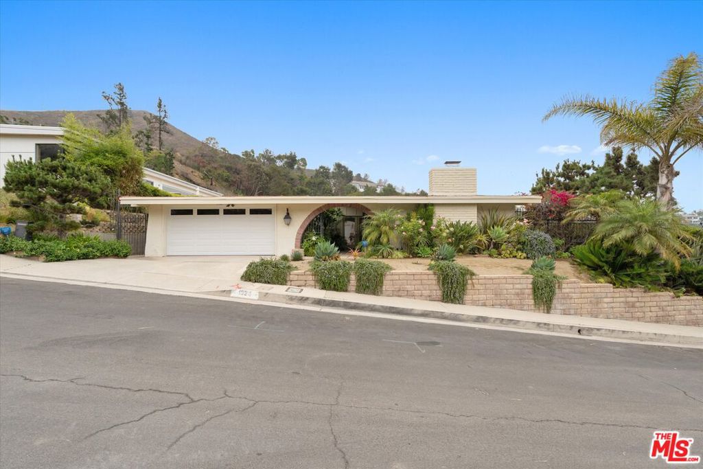 Welcome to 1324 El Hito Circle, a stunning Mid-Century Modern residence with ocean and canyon views. This semi-furnished 4-bedroom, 3-bath home blends timeless design with modern comfort. Designed for effortless indoor-outdoor living, the spacious layout features a living room with a gas fireplace and sliding doors that extend the living space into the backyard. The gourmet kitchen is equipped with a Wolf range, dishwasher, double ovens, and microwave, ideal for both entertaining and everyday cooking. The primary suite opens directly to the backyard and offers a true retreat with dual sinks, a make-up vanity, a large soaking tub, and a separate shower. Additional bedrooms provide flexibility for family, guests, or a home office. Offered unfurnished or partially furnished for added convenience. Surrounding neighbors' homes are still standing in this beautiful section of Marquez Knolls in Pacific Palisades.