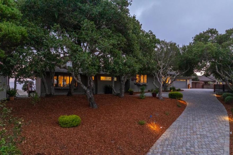 Sophisticated comfort with stunning views. Tucked on a private lane in sunny mid-valley and located in the coveted Carmel School District. This remodeled 3-bed, 3-bath single-story home offers effortless living and entertaining. The open layout includes spacious living, family, and dining areas that flow into a modern kitchen, all filled with natural light from walls of windows. Enjoy the ease of single-story living, two cozy fireplaces, and expansive decks with a fire pit, hot tub, and 180° views of vineyards, Garland Park, Big Sur and Carmel Valley Ranch.  A sunny detached art studio or flexible office space adds even more versatility. Upgraded throughout this home is a must see.