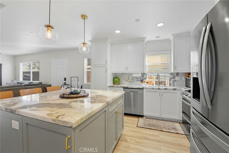 Welcome to this beautiful 4 bedroom home with modern upgrades in a charming community! As you step inside, you'll be greeted by a bright, open-concept living area that seamlessly connects to the recently remodeled kitchen, completed in 2022. As the heart of the home, the kitchen boasts exquisite marble countertops, stainless steel appliances, and modern cabinets accentuated by elegant gold-colored handles. The expanded island offers ample cooking and gathering space, perfect for family meals or entertaining friends. Additional features include a tankless water heater, solar, LVP flooring and a full bathroom on the main floor. Upstairs includes a primary bedroom with en-suite bathroom and three additional spacious bedrooms. Once you step outside you will discover a charming outdoor space, ideal for BBQ-ing and entertaining. Picture summer evenings spent grilling with guests or peacefully relaxing in your private oasis! In this vibrant community, you’ll have access to fantastic amenities, including a park, sports court, exercise stations, a playground, and a community orchard and gardens—everything you need for an active and fulfilling lifestyle! Don't miss out on this perfect blend of modern luxury and community living. Also great for an investment property! Schedule your tour today and make this enchanting home yours!