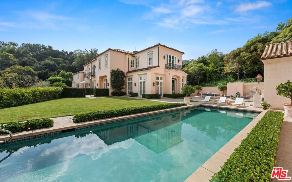 Architecturally designed for world-renowned interior designer Erika Brunson by Bob Ray Offenhauser, "Vivenda da Lua" (House of the Moon) is offered for the very first time. A magnificent Spanish Portuguese villa of exceptional beauty, this rare Bel Air estate is a study in timeless luxury. Three-story main residence and attached guest suite are set behind gates surrounded by manicured grounds, a pool and poolside pavilion, spacious patios, verdant lawns, and formal gardens. Breathtaking gallery has columns of crema marfil marble, grand mural by Doug Riseborough, and finishes by artist Peter Wolfgang. Ten-foot double doors were made from the highest grade wood, fireplaces were hand-picked in Paris, and tiles were designed by Erika Brunson and fabricated by Rigo in Portugal. Magnificent library finished entirely in fine walnut, spectacular gourmet kitchen, temperature-controlled wine room, movie theater, Zen room, upstairs kitchenette, mirrored gym, cupola-topped sweeping staircase, and an elevator.