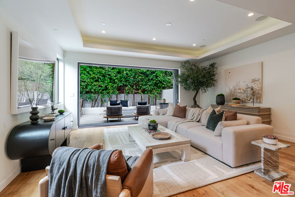 Architecturally sophisticated 4-bedroom, 5-bathroom residence offering a curated blend of contemporary design, elevated comfort, and the quintessential California indoor-outdoor lifestyle. Nestled in the heart of Mar Vista, this modern retreat is bathed in natural light, with soaring ceilings and wide-plank hardwood floors that create an effortless sense of openness and flow. At the center of the home, a chef's kitchen makes a striking impression featuring premium Thermador appliances, sleek custom cabinetry, and a bold center island designed for both casual gatherings and elevated entertaining. Expansive glass doors seamlessly dissolve the boundary between inside and out, leading to a private backyard oasis complete with a BBQ and designer fire pit. Upstairs, the primary suite offers a true sanctuary an oversized layout complemented by a spa-inspired bath with soaking tub, rain shower, dual vanity, and custom walk-in closet. Each secondary bedroom features its own en-suite bath, offering luxurious comfort and privacy. The top-level suite provides unmatched flexibility, ideal as a guest retreat, executive office, or bespoke wellness studio. Step out onto the show stopping rooftop terrace where a spa-quality hot tub, fireplace, and integrated beer tap create the ultimate setting for sunset cocktails or relaxed weekend entertaining, all set against the backdrop of Mar Vista's skyline. Designed with smart and sustainable living in mind, the home is equipped with paid-off solar panels, a Tesla EV charger, Control4 smart home automation, and Lutron lighting throughout. With no shared walls, no HOA, and no monthly fees, this freestanding residence delivers privacy and autonomy without compromise. Located moments from Venice, Santa Monica, Culver City, and close proximity to 10fwy and 405 fwy, 3658 Beethoven is more than a home it's a refined expression of Westside living at its finest.