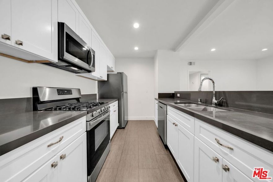 TOP FLOOR light & bright remodeled large one bedroom apartment in the heart of Lake Balboa. Open remodeled kitchen with lots of counter space and brand new appliances. There is also a spacious patio off the living room. Laminate wood floors throughout. Other features include central A/C, recessed lighting and one assigned parking spot in a gated garage. Smaller 10 unit building building with digital video controlled access. PET FRIENDLY.