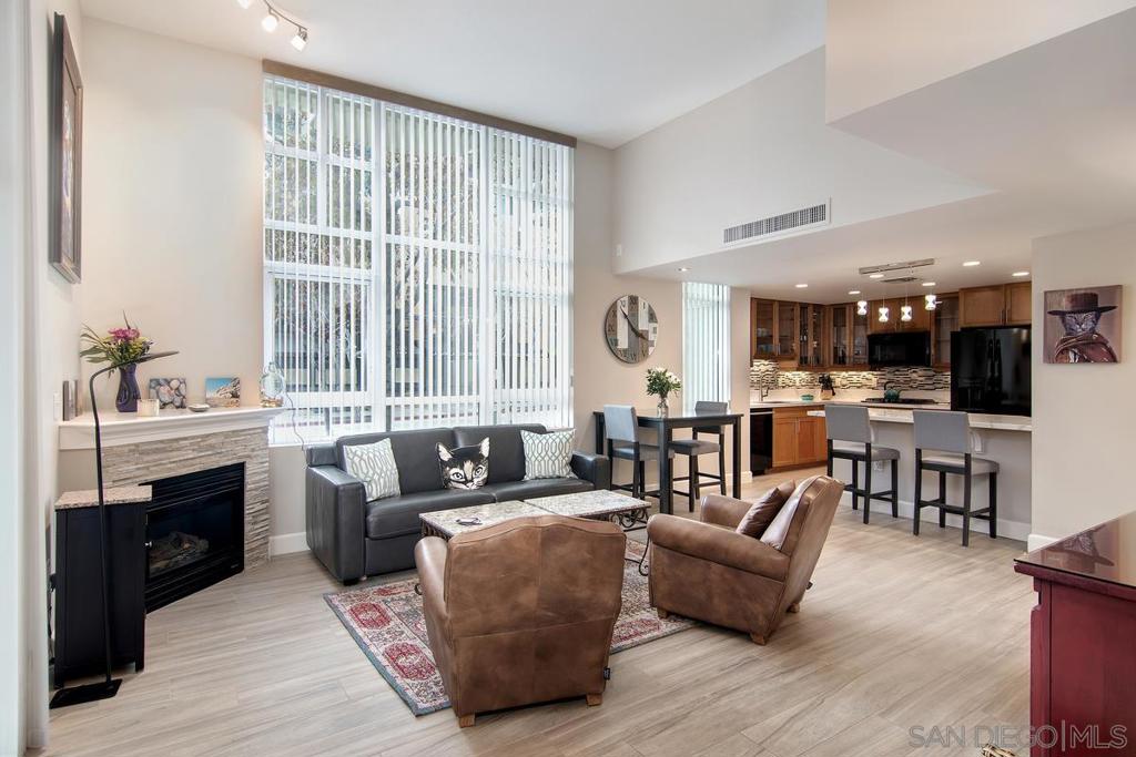 This three-level, tastefully decorated townhome boasts 1,500 square feet of indoor living space equipped with everything to make you feel at home, including a brand-new AC system. Private street access mitigates the need to pass through a common lobby. The ground level includes a large living area with vaulted ceilings, gas fireplace, 65? Smart TV, and 9’x9' window for ample natural light; a kitchen with large quartz island, bistro table, all-new updated appliances throughout, including a gas cooktop/electric convection oven, and dual zone wine refrigerator; a half bath; and two large closets. The second level is the guest suite with a king-sized bed, large closet, Smart TV, and full bath. The third level is a large master suite with a king-sized bed, two huge closets, a Smart TV, small balcony and a full bathroom. This luxurious ensuite bathroom featuring freshly updated tilework, a spacious walk-in shower, freestanding bathtub and a sizeable copper trough sink with dual faucets. This level also houses a separate laundry room, featuring a new washer and dryer, with lots of storage. The real gem of this unit is the 500 square foot patio off the living room! Surrounded by palm trees and flowering plants, you’ll feel like you’re at a resort as the subtle sound of the courtyard waterfall relaxes you. This unit is within the Horizons community in the heart of the Marina District! This locale offers a perfect dose of urban appeal and access to recreational areas, just minutes from the San Diego Convention Center, Seaport Village, The Embarcadero, The New Children’s Museum and the Gaslamp Quarter-areas rife with spots to peruse boutique shops or to grab a tasty bite and brew. The close by Martin Luther King Jr. Promenade offers a superbly landscaped linear park that is a favorite for pedestrians, joggers, dog walkers and families alike, as the Children’s Park is located along the promenade. Amenities in this gated community include 24-hour security and concierge services, secure underground parking, an updated fitness center, community rooms in each tower equipped with kitchens and lounges and a recreation room with billiards and a wet bar. Outdoor features include a heated swimming pool, jacuzzi, BBQ area with outdoor seating, sun deck with lounge furniture and an interior courtyard featuring a magnificent coral tree as the centerpiece of lush tropical landscaping that also contains a splendid waterfall, adding to the resort-like ambiance.