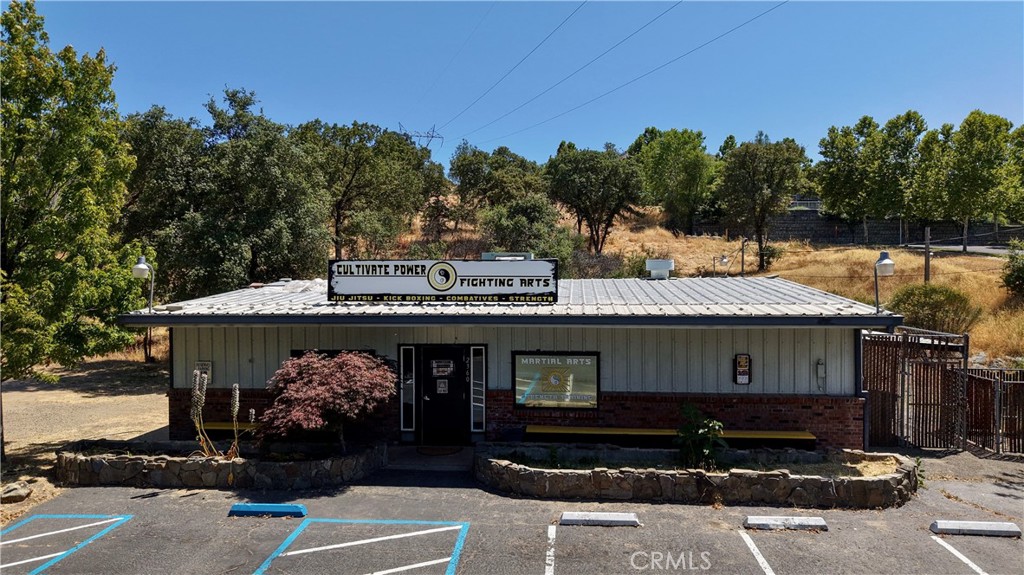 Unlock the potential of this 1,940 sq ft commercial unit situated on over half an acre with its own private parking lot. Centrally located and just minutes from downtown, this highly visible property offers easy access right off a main thoroughfare—ideal for potential clientele. Currently operating as a martial arts studio, the flexible open layout makes it a perfect fit for a wide range of business ventures including fitness, wellness, retail, office, specialty services, and more! The generous lot size provides ample room for expansions or events. With great visibility and close to Oroville Hospital, this property is a rare find for investors or owner-users looking to grow their business.