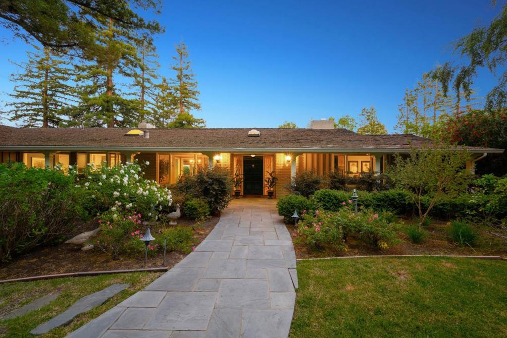 Spanning just under one acre in the heart of central Atherton, this property exudes resort living with a pool and spa, tennis court, and vast terraces for lounging and dining. The private corner lot with gated entrance surrounds a classic California ranch home that is traditional and timeless with hardwood floors, refined moldings, and numerous French doors. The spacious one-story home has 5 bedrooms arranged in two separate wings, plus a family room and pool-side recreation room. Resort-inspired grounds include a vast terrace with fire pit and built-in barbecue center with refrigerator and sink, separate terrace with wood-burning fireplace, arbor-covered dining area, pool and spa, plus tennis courtAdding the finishing touch is access to excellent Menlo Park schools.