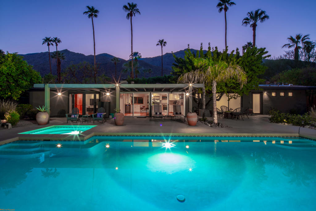 Tucked behind private gates and lush greenery in Tahquitz River Estates, this beautifully maintained 3-bedroom, 3-bathroom home offers nearly 2,000 square feet of seamless indoor/outdoor living. Sunlight fills the open floor plan, which features spacious living and dining areas, a well-equipped kitchen, and thoughtful updates that blend classic Palm Springs charm with modern finishes. Each bedroom is paired with a nearby bathroom, providing a private and practical layout for residents and guests. Step outside to your backyard oasis, where a large pool and spa create a resort-like retreat, surrounded by mature landscaping, multiple seating areas, and clear views of Mount San Jacinto. Designed for both relaxation and entertaining, the space combines serenity with private seclusion. Sitting on fee land (you own it) with no HOA, this home places you just minutes from the vibrant heart of Palm Springs, with its renowned restaurants, boutique shops, galleries, and entertainment at your doorstep. Ideal as a full-time residence, weekend getaway, or high-demand vacation rental. (As of September 18, 2025, Tahquitz River Estates is well below the 20% vacation rental cap, further enhancing its appeal.) Experience the ultimate Palm Springs lifestyle, combining comfort, style, and unmatched views in this private desert retreat.