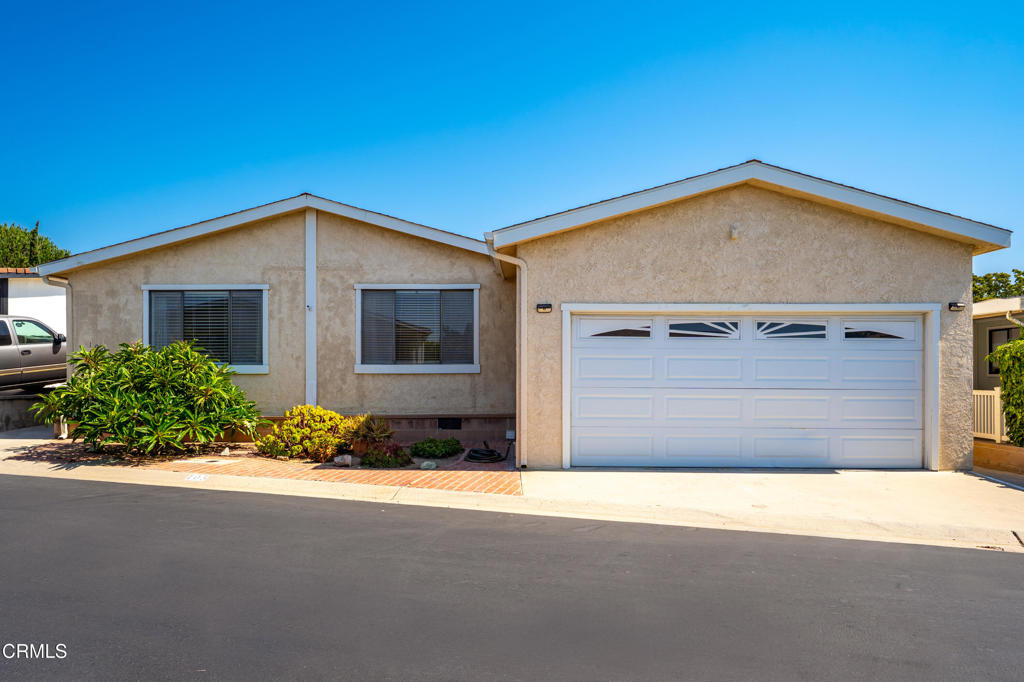 Gated community ~ Large 2 bedroom, 2 bathroom manufactured home in an age restricted complex (55+) where you own the land, NO RENT! HOA is $357.00 per month and covers all community amenities (pool, clubhouse, fruit trees, game room and more) and some utilities (water / sewer, trash and basic cable). This home is approximately 1680 sq ft, sitting on a good sized lot (approx. 4464 sq ft), large living room, fireplace, dining area, 2 built in hutches, tons of extra storage, huge walk in closet in primary bedroom, large concrete patio with a fantastic area to garden in the raised beds. Large utility room with built in desks / work space, private interior laundry, 2 car garage, workshop / shed and air conditioning! RV parking lot available too.
