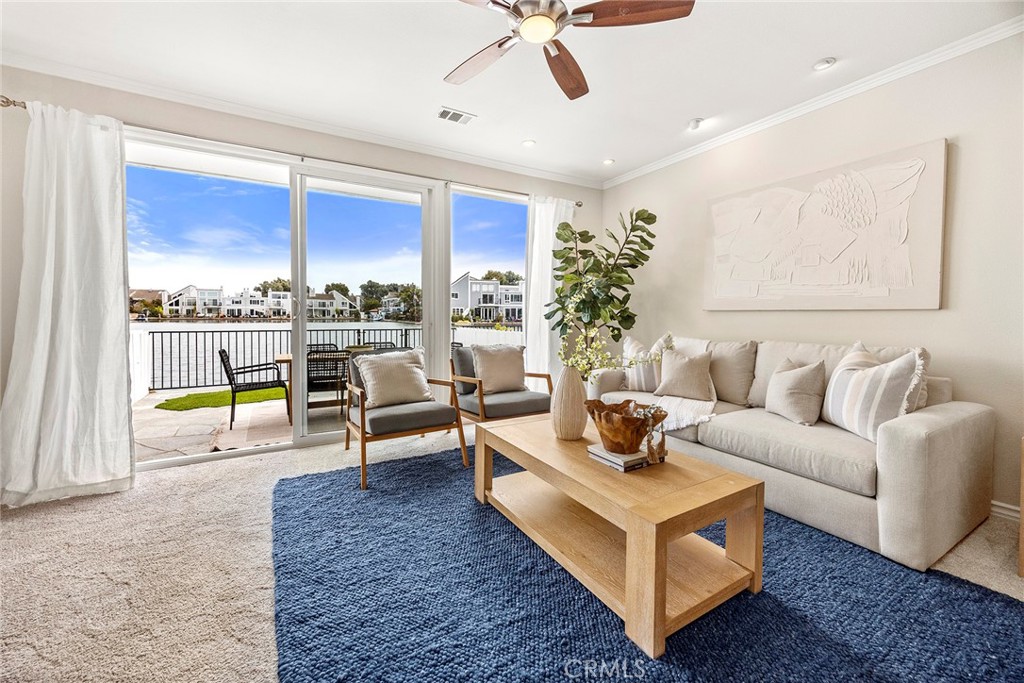Welcome to 3742 Montego Drive, a thoughtfully upgraded waterfront townhome nestled in the prestigious Seagate community of Huntington Harbor. With 3 bedrooms, 3 bathrooms, and 1,890 square feet of light-filled living space, this home blends coastal charm, modern upgrades, and resort-style amenities. Situated on the lagoon, the home offers serene water views from the living room, backyard patio, and private balcony off the primary suite, where you can enjoy morning coffee or evening sunsets while paddle boarders glide by. The main level welcomes you with a formal entry and a spacious living room featuring a fireplace with new doors, updated can lighting, and sliding glass doors that open to the patio. The updated kitchen offers stainless steel appliances, a breakfast bar, and plenty of storage, seamlessly connecting to the dining area—perfect for entertaining. Upstairs, the primary suite boasts stunning water views, vaulted ceilings, a walk-in closet, and an ensuite bathroom. Two additional bedrooms provide flexibility for guests, family, or office use. Community amenities include pools, tennis courts, a clubhouse, and beautifully landscaped grounds, all just minutes from the beach, shopping, dining, and top-rated schools. This home offers a rare chance to experience the coastal lifestyle in one of Huntington Harbor’s most desirable communities. NO Boat Slip included