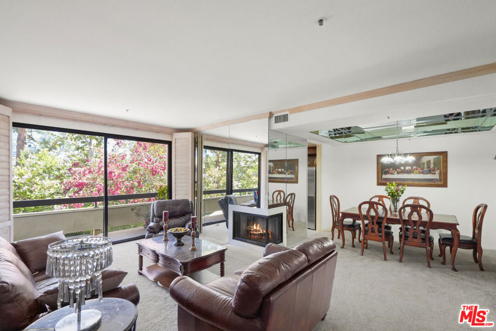 Experience elevated living in the highly coveted, luxury, guard- gated Park Place, providing both privacy and security for its residents, just moments from Beverly Hills! Set in one of the complex's most desirable locations on Galaxy Way. The total square footage of 1,680 allows for plenty of room to entertain guests or simply relax and unwind. Convenient, rectangular, simple to understand layout. Only one shared common wall on the left side. As you enter the home, you will be greeted by an abundance of natural light that floods the open floor plan. This quiet, 3 bed or 2 + large Den, 2 full bathroom home has it all. Large and comfortable living space with fireplace. Soaring ceilings. A private balcony with floor-to ceiling sliding glass doors, a formal dining room. Spacious kitchen with breakfast area, and big windows. The two private bedroom wings. A generous primary suite with walk -in closet, makeup and double sink vanities, dressing area, built- in linen cabinets. The second, open bedroom accented by sleek, built-in wall closets offering abundant storage while keeping the design clean and modern. Shared balcony. The third bedroom/den with wooden parquet and sliding glass doors has access to the balcony. Residents enjoy resort-style amenities, including pools, tennis courts, 24/7 security, and lush landscaped grounds. With proximity to Westfield mall, Rodeo Drive, Westwood, and top dining destinations, this homes combines privacy, elegance, and convenience. Laundry in hallway's closet, new carpet, partially painted, wooden plantation shutters. Side - by -side parking with storage included. Don't miss this rare opportunity --schedule your private showing today! Several photos are staged virtually. Please watch a gorgeous video and a 3D video tour. Thank you.