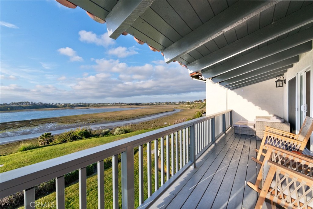Available 8/13/2025 3D Scan - Beautifully remodeled Extended Stay 3-bedroom, 2.5-bath, 2-story home with a brand new 600 sq ft patio facing Back Bay. This property has a private patio which includes a hot tub & barbecue. It has plenty of natural light and a spacious living room that overlooks the Newport Back Bay. The living room also has a fireplace and a large wall-mounted flat screen TV. The King master bedroom has a beautifully appointed en suite bath with a large walk-in shower. The 2nd bedroom, has a Cal-King bed, and the 3rd bedroom has a Queen bed - comfortably sleeping 6 people. These two bedrooms share a bath with a shower/tub combination, and there is an additional 1/2 bath for your convenience. Each bedroom has a mounted flat screen TV. Parking available for 2 cars, EV Charging, WiFi, cable, and a washer and dryer.