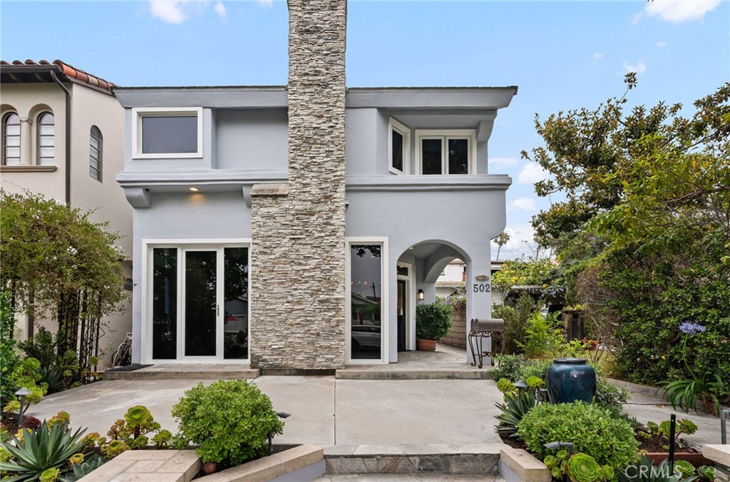 Perfectly located in the heart of Corona del Mar, this renovated three-bedroom, two-and-one-half bath front condo flows from the sophisticated living room with fireplace, French door and front Dutch door leading to a spacious front sun-filled patio. Continue through the dining room to a large, light, open kitchen, and family room with high ceilings, a ceiling fan, and recessed lighting. The kitchen has been updated with new cabinets, fixtures, and lighting. There is a Dacor cooktop, Kitchenaid double ovens, and Bosch dishwasher and a new Microwave drawer. The light-filled staircase leads to a sizable primary en-suite bedroom replete with 2 cedar lined closets and fireplace. The luxurious bath includes double sinks, stone counters, a separate shower, and a soaking tub. There are an additional two bedrooms connected by a bathroom. On the 3rd level there is a large landing suitable as an office space with a storage closet. The rooftop deck affords a peek-a-boo view of the ocean as well as gorgeous sunset skies. An inside laundry room leads to a one-car garage with storage plus a carport. With high ceilings throughout, wood floors, 2 stone fireplaces, A/C, ceiling fans, ample storage and closet space this home is very special.