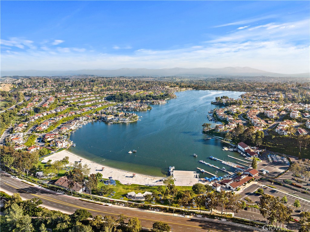 This beautifully remodeled lakefront condo is in the highly sought-after gated community of Finisterra on the Lake. This two-bedroom, two-bath home offers approximately 1,333 square feet of thoughtfully designed living space, blending modern updates with a relaxed waterfront lifestyle.
Step inside to an open and bright floor plan where the kitchen has been upgraded with quartz countertops, custom cabinetry, stainless steel appliances, and a stylish backsplash. The living area flows seamlessly to a private patio with direct lake views, perfect for enjoying a morning coffee or evening glass of wine while taking in the water. A cozy fireplace anchors the family room, while new flooring and updated lighting throughout add to the home’s fresh, contemporary feel. Each bedroom features its own private bath with high-end finishes, providing comfort and privacy for both residents and guests.
Life at Finisterra on the Lake means resort-style amenities at your doorstep. Residents enjoy access to a private beach, pool, greenbelts, boat docks, and all the recreation Lake Mission Viejo has to offer, from paddleboarding and kayaking to summer concerts on the sand. The gated community is secure and peaceful.
Located in one of Orange County’s most desirable neighborhoods, this home offers easy access to top-rated schools, shopping, dining, and major freeways, making it as convenient as it is picturesque. With its turn-key updates, waterfront setting, and unbeatable lifestyle, 27913 Trocadero #68 is a rare opportunity to own a slice of lakeside living in Mission Viejo.