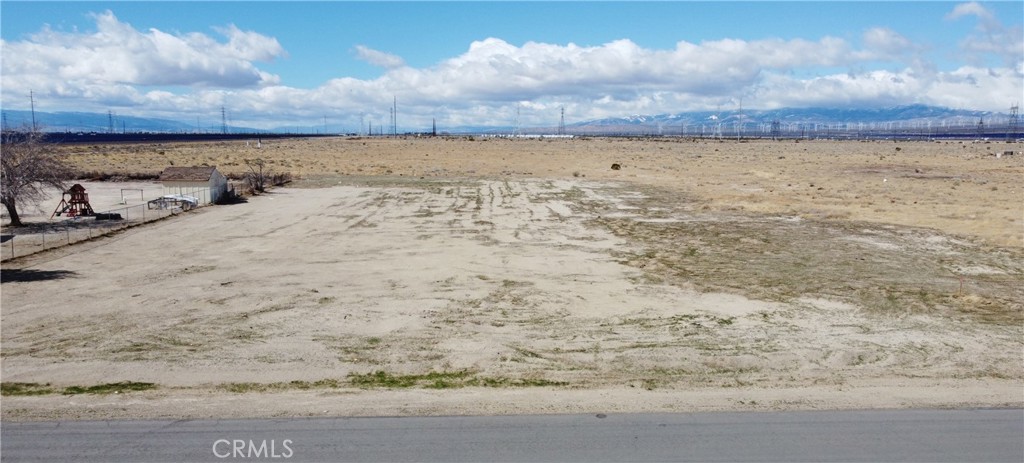 Prime location of just over 1 acre lot in Rosamond. Land has been GRADED and SURVEYED. Established homes on adjacent lots, perfect location to build your dream home. It is off of a paved road with power poles on flat terrain with breathtaking mountain views. Located just off of 100th st W & Holiday ave. Rosamond is an unincorporated town of around 18,000 at the hub of what has been called "Aerospace Valley". Rosamond is the gateway to Edwards Air Force Base, and is just south of the emerging civilian spaceport at Mojave. Explore the possibilities and take advantage of this amazing opportunity today!