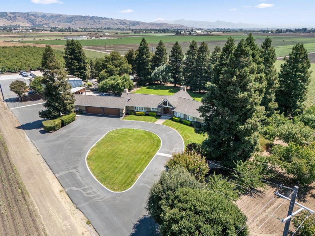 ONE Of A KIND ESTATE on 5.89 acres! Privacy abounds yet so close to everything! Main House features *3699 sq ft single story *4 bed/3 1/2 baths *Beautifully remodeled *Hardwood floors *Dual zone A/C and heat *Vaulted ceilings *Custom kitchen with granite slab *Double ovens *Sub Zero refrigerator *Sub Zero Beverage refrigerator *Center island *2 fireplaces *Primary suite with stall shower and jetted bathtub *4 car finished garage with custom cabinetry *Separate 5th garage with private entrance *Pool house w/full kitchen and 1/2 bath *Paver patio *Pool w/spa *Outdoor kitchen with pizza oven, 48in BBQ and side burner, sink, refrigerator, wine refrigerator, leather finished granite slab *Outdoor fireplace *Pickleball court *Bocce Ball Court *Garden greenhouse *Separate 4000 sq ft workshop with 3 offices and yard space *Expansive lawn area *Producing walnut orchard *Generac Generator...and so much more! Homes like this rarely come on the market. Don't miss the opportunity to call it home!