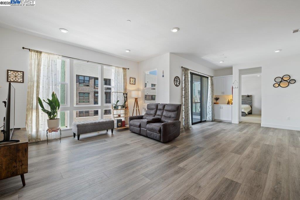 Welcome to Metro West by Toll Brothers, a contemporary 2023-built condo located in Fremont’s Innovation District. This modern condo offers high ceilings, expansive windows, and an open-concept floor plan that blends style and functionality. The spacious living and dining areas flow seamlessly into a beautifully appointed kitchen featuring a large center island, quartz countertops with full backsplash, ample cabinetry, and stainless steel appliances—ideal for entertaining or everyday living. The primary suite is a private retreat, complete with a generous walk-in closet, double sink vanity, and a sleek walk-in shower with premium finishes. Additional highlights include an in-unit washer/dryer, private 1-car garage, and elevator access to your floor. Community amenities include a rooftop lounge with BBQ grill and firepit, a state-of-the-art fitness center, pet grooming station, and co-working spaces and meeting rooms. Located just minutes from Warm Springs BART, highways 880 and 680, major tech employers, shopping, restaurants, and groceries. Bringhurst Elementary school across the street. Enjoy luxury, convenience, and modern living all in one place!