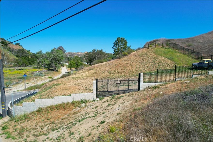Discover the opportunity to own this land nestled in the peaceful community of Val Verde. Located on Taylor Avenue (34.44327000 -118.65563000), this parcel offers a serene, rural setting with stunning hillside views and natural surroundings—perfect for investors, developers, or anyone looking to build their dream home or getaway. The property is secured with an attractive brick and iron gate, adding both charm and privacy. With nearby access to utilities (buyer to verify), this property offers both seclusion and convenience, just minutes from Valencia, Castaic Lake, and the I-5 freeway. Enjoy country living with city access in this growing area of Los Angeles County. Don’t miss your chance to own a slice of SoCal nature!