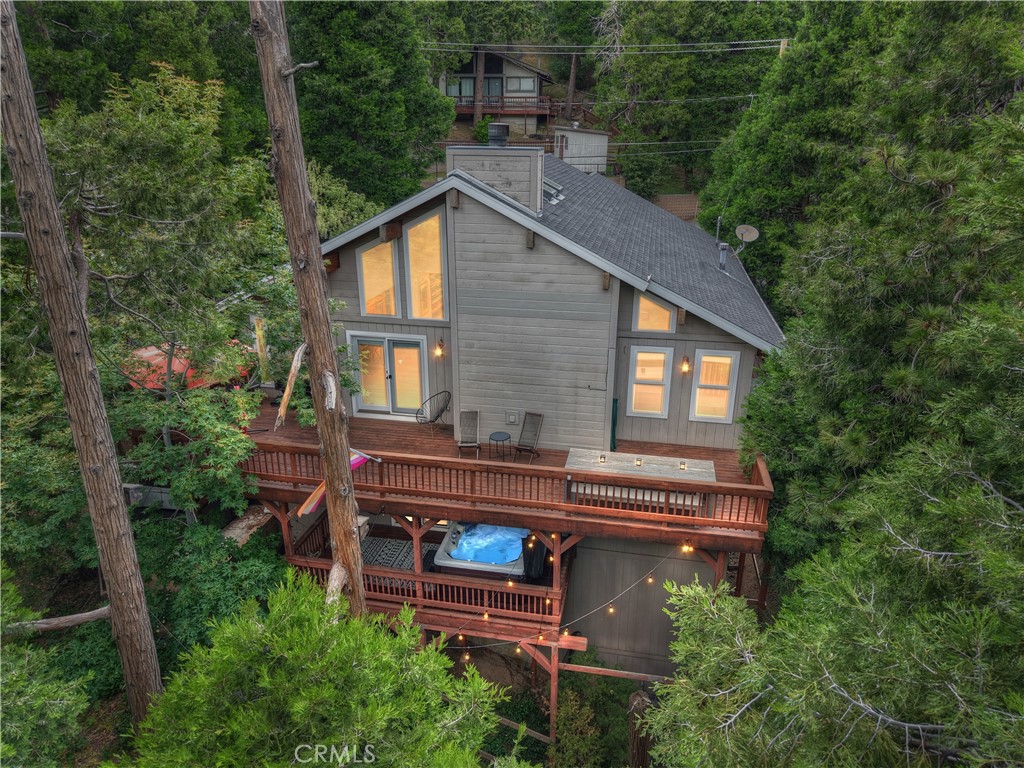 If the Mountains are calling...here's your well-appointed Mountain Chalet in the coveted San Moritz area of Crestline. Just around the corner (walking distance!) from beautiful Lake Gregory with its Water Park, Swim Beach, Lake Trail, Skate Park, Fishing, Boating, Kayaking, Paddle Boarding, and Dog Park. Easy access on a Plowed and Maintained road with Level Entry and an Attached 2 Car Garage for Easy Mountain Living. Open Floor Plan Living/Dining with Soaring High Ceilings and centerpiece Fireplace for those Cozy Winter Evenings. A Large Deck overlooking the pines to grill, gather and lounge. A Master Suite with its own Private Deck, complete with Jacuzzi. Wide Staircase and Hallways give a sense of comfortable expansiveness. Plenty of room for your Family or Guests with 3 bedrooms and an additional room - currently being used as an office - could be a 4th bedroom. Not to mention your own personal Mountain Spa Retreat including a SwimSpa and outdoor Infrared Sauna. Oh..and there's a Natural Water Spring surrounded by Blackberry bushes in the yard! This is a beautiful, newer Home for the area in a GREAT location. Escape from the Flatlands this Summer to enjoy all the magical San Bernardino Mountains have to offer.