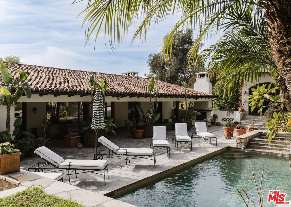 Your dream lifestyle awaits in this exclusive offering of a private Tuscan-inspired estate, known as Villa-Villa. Set on over half an acre of lush gardens in the heart of Beverly Hills, this celebrity compound spans over 11,500 sq. ft. across three meticulous structures, featuring 7 bedrooms, 11 bathrooms, a gourmet chef's kitchen, a warm and inviting family room with an adjoining office, a grand living room with soaring 30-foot ceilings, a formal dining room with a built-in bar, a custom screening theater, and a spacious upper-level living room. The resort-style grounds include a sparkling pool and spa, sauna, cabana with kitchen, multiple patios, and a rooftop terrace with Pacific Ocean views. An enclosed vegetable garden and viewing deck add to the expansive outdoor living amenities. Dual primary suites boast private loggias, spa-inspired baths, and expansive walk-in closets, while a separate two-bedroom guest house offers its own private entrance and charming courtyard. Perfectly positioned next to Trousdale Estates, Villa-Villa delivers unmatched privacy while being just moments from the Beverly Hills Hotel, Sunset Strip, and Century City- a true sanctuary blending timeless elegance, modern luxury, and resort-style living.