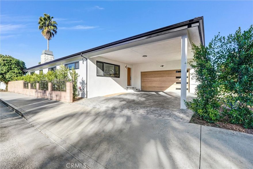 This beautifully reimagined 4-bedroom, plus office, 3-and-a-half-bathroom residence sits gracefully on a corner lot along one of the area’s most picturesque, tree-lined streets. Every element of the home has been thoughtfully redesigned to blend sophistication, natural light, and seamless flow throughout.



An inviting foyer opens to expansive, open-concept living areas where high ceilings, skylights, and refined finishes create an effortless sense of space. Just off the entry, a private enclosed office with glass double doors offers the ideal work-from-home retreat — quiet, functional, and filled with light.



At the heart of the home lies the designer kitchen, anchored by a large island and countertops crafted from Taj Mahal quartzite, White Oak custom cabinetry, and premium appliances. Thoughtfully designed for both gatherings and everyday living, it opens to the dining area and an inviting family room with a fireplace — all connected by sliding doors that open to a covered patio framed by greenery and subtle landscape lighting — creating a warm, intimate space ideal for dining al fresco or entertaining close friends.



The primary suite serves as a tranquil escape with direct access to the backyard and a spa-inspired bath complete with a freestanding soaking tub. Each of the home’s bedrooms is exceptionally spacious, offering comfort, versatility, and beautiful natural light — ideal for family, guests, or creative use.



Every detail reflects quality craftsmanship and timeless design — a modern home set within one of the neighborhood’s most desirable and inviting settings. The property’s wrap-around driveway, bordered by lush ficus trees, enhances both curb appeal and privacy, offering generous parking with a carport and a large garage. Ideally located within walking distance of the shops and restaurants along Ventura Boulevard, with convenient freeway access and highly rated schools nearby.