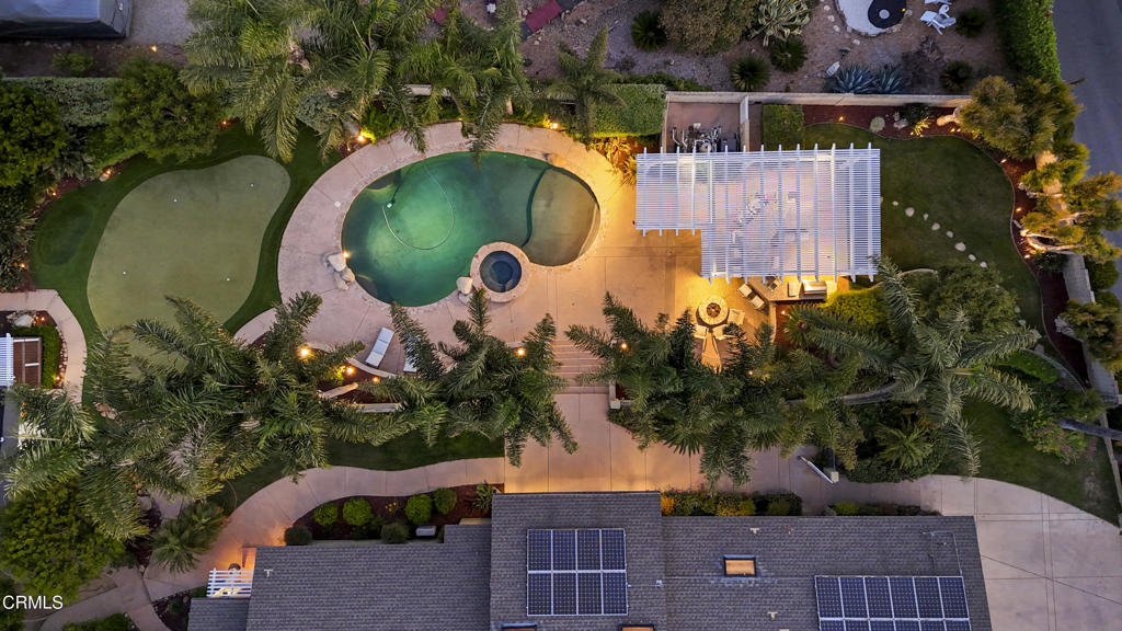 Tucked into the hills of Camarillo Heights, 590 Alosta Drive is a rare opportunity to own a private, view-filled estate with unmatched versatility and charm. This single-story home sits on an almost 25,000sqft lot and features a sparkling pool, detached ADU, detached workshop, home office, BBQ area, professional putting green, owned solar panels, and views of the ocean, mountains, and city of Camarillo.The main residence offers an open and airy layout with tasteful updates throughout. The kitchen and main living area are impressively large and open, offering the perfect space for entertaining, relaxing, and everyday living. Natural light pours through dual-pane windows, framing serene vistas in nearly every direction. The living and dining areas flow effortlessly to the outdoor space--perfect for indoor-outdoor entertaining or quiet evenings by the pool.Step outside to your own private oasis: a large pool area surrounded by lush landscaping, outdoor BBQ area with covered patio, avocado and citrus trees, and multiple gathering areas. A detached ADU offers complete flexibility for multigenerational living, rental income, or a spacious home office. There's also a separate workshop ideal for hobbies, storage, or business use.Set in a quiet, established neighborhood with no HOA and just minutes from schools, parks, and the 101, this is a truly unique property. Whether you're looking for a turnkey family home, an income-generating property, or a private retreat with room to grow, 590 Alosta Drive offers it all.