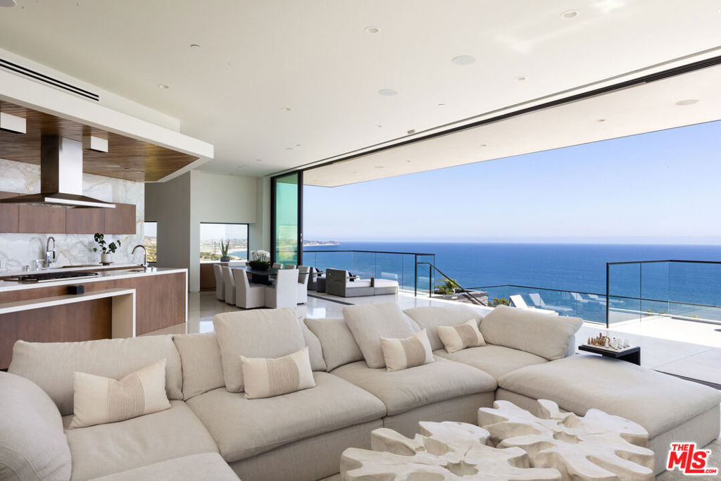 A rare chance to own one of Malibu's premier newer-construction estates, where luxury, privacy, and panoramic ocean views converge. Set behind gates on nearly three private acres across from iconic El Matador Beach, this 10,000 sq. ft. architectural statement showcases unobstructed views of the Pacific, Catalina Island, and the Santa Monica Mountains. Crafted for the most discerning buyer, the home is designed with scale, elegance, and ease of living in mind. Soaring ceilings and walls of glass flood the interiors with natural light, seamlessly blending indoor and outdoor living. Smart home automation by Crestron offers complete control of lighting, climate, entertainment, and security. Ideal for both grand-scale entertaining and quiet coastal living, the residence features a dramatic ocean-view pool and spa, a true chef's kitchen, formal dining room, and expansive living spaces that frame postcard-worthy sunsets. Additional amenities include a private office, a fully-equipped gym, an 800-bottle wine cellar with tasting lounge, and a cutting-edge home theater. The 1,300 sq. ft. primary suite is a private sanctuary, complete with dual walk-in closets, a spa-inspired bath, and sweeping vistas that stretch from sunrise to sunset. A gated motor court, four-car garage, elevator, and full surveillance system ensure convenience, security, and discretion. This is Malibu living at its finest, an extraordinary estate that embodies the coastal lifestyle. Private showings available by appointment.