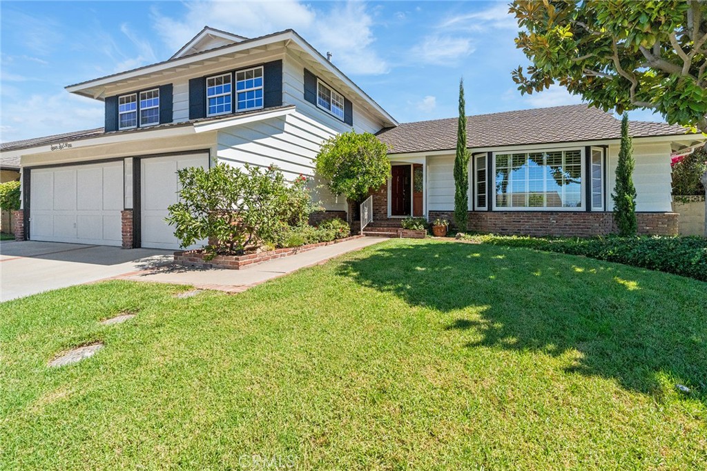 Discover this delightful 5 bedroom, 3 bathroom, lovingly maintained home located on a quiet cul-de-sac in one of Orange’s most desirable neighborhoods. With its English garden landscaping and breath catching curb appeal, this home welcomes you with timeless style and endless possibilities. Inside the generous 2,604 square foot home, the thoughtful floor plan offers both functionality and flexibility. Enter into a foyer that leads you to either the formal living room with its oversized windows or into the kitchen, breakfast nook, family room. The kitchen, which looks out onto the garden, is open to the cozy and inviting family room with its fireplace. A paned sliding glass door leads you to the covered patio which is perfect for dining al fresco year-round with family and friends, or enjoying a sun-filled, quiet morning coffee. You can relax and watch the kids or dogs playing on the grass which is lined with fragrant roses and other beautiful easy to care for landscaping. A formal dining room off the kitchen also has a sliding door to a morning patio leading to the backyard. This is an entertainer’s home just waiting for you to make it your own. The main floor bedroom, next to a full bathroom, can be a private office or bedroom. Upstairs, the primary suite with its double door entry, offers an oversized yet comfortable retreat, while three additional large bedrooms with their beautiful plantation shutters provide plenty of room for everyone. A cozy bonus space, off the separate downstairs laundry room, was once a sewing room; it lends itself to a creative nook or extra storage. The 3-car garage has direct access into the house, storage, and a workbench. With fresh paint and new carpet throughout, this residence is move-in ready yet offers a remarkable opportunity for you to bring your vision and transform it into a fabulous, updated home. All these features, just 2.5 miles from the historic Orange Plaza, and minutes to shopping and the 22 and 55 freeways, make this home the perfect blend of charm, convenience, and potential.
