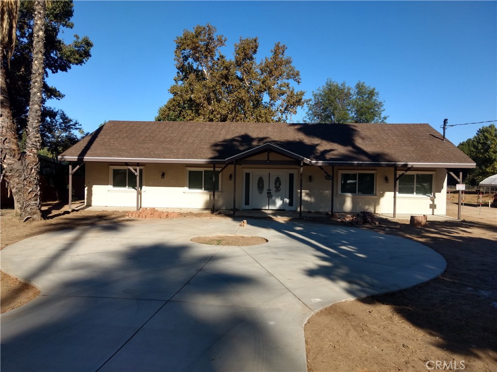 Immaculate single story horse property on 1/2 acre. This house was completely remodeled in 2019. The remodel included a full upgrade of the entire property & expanded the house with an additional 750 sqft. With 4 very nice sized bedrooms and a den, the master bedroom on the East end of the house with all other bedrooms on the West end. 3 full bathrooms, a huge open kitchen / living room and dining area. Granite kitchen counter tops, newer cabinets, all new wood flooring, a circular covered patio area. Indoor laundry with plenty of space. Central AC & Heat. A detached large 2 car garage with 200 volt plug in. A must see to appreciate. Additional 1.5 Acres in the back is negotiable and could be used for horses, nursery or livestock.