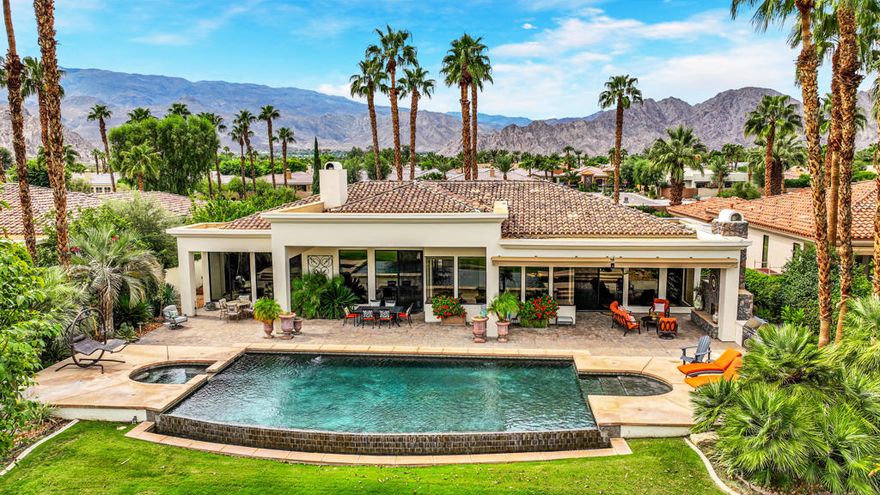 Set against a spectacular lakeside backdrop with breathtaking mountain and golf course views on the 11th hole of the Weiskopf Course, this stunning home feels like a model. Offering approximately 4,828 sq. ft. of pure luxury, it features four bedrooms, including an office, 4.5 baths, and a private two-room casita. Designed for both comfort and style, the open floor plan boasts a spacious gourmet granite island kitchen with Wolf & Sub-Zero appliances, a granite sunken bar showcasing the incredible views, and elegant 24-inch travertine floors. Additional highlights include fresh new paint inside and out, electric shades, and a private gated entry courtyard with tranquil water features.The resort-style backyard is an entertainer's dream, complete with pavers, a saltwater infinity pool and spa, an outdoor fireplace, a fire pit, a built-in BBQ, and more. The home comes fully furnished and includes a golf cart--making it completely move-in ready. With low HOA fees and an unbeatable location, this extraordinary home offers the ultimate lifestyle. Call now to schedule your private showing of this spectacular property!