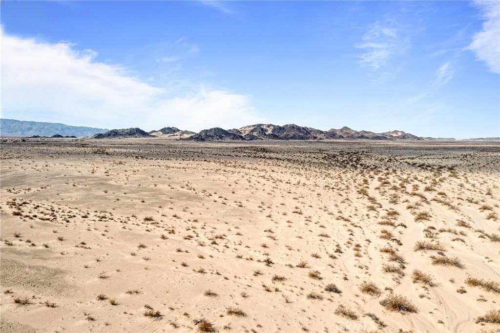 Incredible opportunity to own 60 acres of raw, untouched desert in Wonder Valley, located near the base of the mountains with sweeping 360-degree views and no immediate neighbors. The land offers unmatched privacy, making it the perfect setting for a future off-grid retreat, creative desert build, or long-term investment. Situated just a short drive from the eastern entrance of Joshua Tree National Park and downtown Twentynine Palms, this property combines remote tranquility with easy access to essentials. The lot is ideal for stargazing, with wide open skies and minimal light pollution—experience the quiet stillness and natural beauty that make Wonder Valley so sought after. No address has been assigned; the address used is fictitious. For directions, use LandGlide parcel number 063420107. No seller financing—cash only. Buyer to verify utilities, zoning, and development potential.