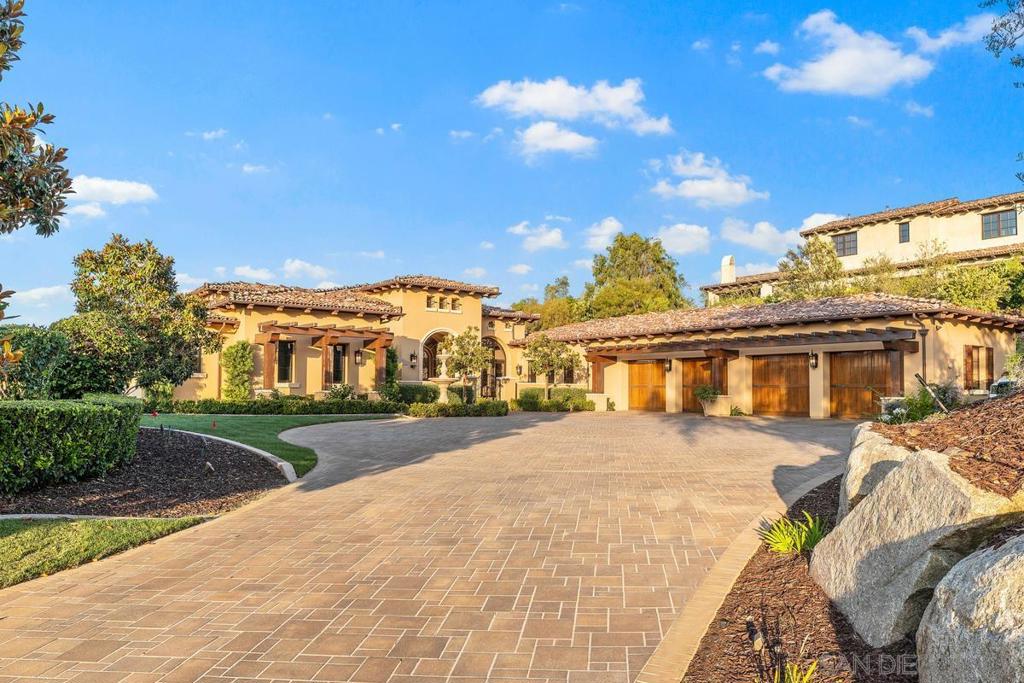 Enjoy life at The Crosby in this exquisite custom Single Level home that is the ultimate for indoor/outdoor living with stunning Mountain, Lake and Golf Course views! Timeless and elegant w/soaring beamed ceilings, stone flooring, custom molding and exceptional interior design. Entertain in a bright chef's kitchen, open great room, wine bar loggia w/a vanishing glass wall overlooking the infinity pool/spa, outdoor kitchen, firepit, set high above the golf course. This huge cul de sac lot has a motor court for plenty of parking! Enjoy life at The Crosby in this Single Level Luxury home situated on a secluded cul de sac within the gates of The Crosby Estates at Rancho Santa Fe. Built in 2014, by Danny Hampel with timeless contemporary elements including dramatic 18' ceilings, stone flooring, box beamed ceilings, extensive woodwork and built ins. An executive office and formal dining room greet you as you enter the foyer where you will be amazed at the breathtaking views through to the backyard. Open and bright floor plan with wide hallways, a Chef's kitchen that includes Thermador and Sub Zero appliances, a built in breakfast table, vegetable sink, pasta faucet, butler's pantry and a dining area which flows freely into the great room featuring a 15' vanishing glass wall leading out to a heated loggia, built to capture spectacular mountain, lake and golf course views! Entertain inside at the bar w/wine cellar or outside by the pool/spa/grill and bar. Nestled on approx. 1 acre this home has plenty of parking in the motor court with a fountain in the front of the home. Minutes to the village of Rancho Santa Fe and approx. 10 miles to local beaches and the Del Mar Racetrack. Excellent Rancho Santa Fe schools!