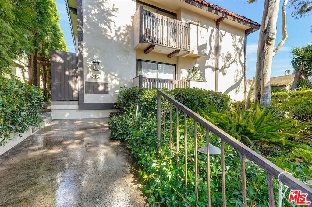 Step into this inviting, freshly painted townhome featuring a classic layout with modern touches. The main level offers gleaming hardwood floors, a bright open living area with cozy fireplace, and two semi-private patios perfect for relaxing or entertaining. The spacious dining area flows seamlessly outdoors to a larger patio, ideal for alfresco dining. Upstairs, you'll find two generous bedrooms, each with its own en-suite bath. The primary suite includes a cozy fireplace, walk-in closet, semi-private balcony, and an additional closet for extra storage. Additional highlights include BRAND NEW double pane windows throughout, carpet upstairs, recessed lighting, plantation shutters, double linen closets, and a convenient first-floor powder room. Enjoy direct access to a private two-car side-by-side garage with washer and dryer. This small, intimate building, located just moments from Montana Avenue's vibrant shops and cafe's, combines comfort, style, and unbeatable convenience. A must see!