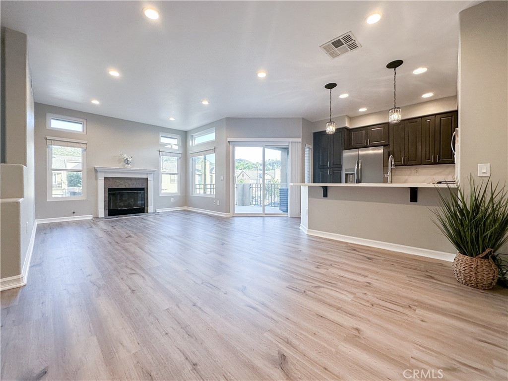 REMODELED LAST YEAR WITH PERMITS!!! Freshly remodeled 2 bed 2 bath luxury end unit in quiet Summit Court Community. No one above or below! Located in the attendance area for the highly rated Canyon High School. Featuring 9ft ceilings, and almost everything is new: paint, floors, kitchen, bathrooms, closets, windows, slider, light fixtures, etc. Walk up the stairs to the open concept living room/ dining room / beautifully redone kitchen with matching stainless steel Frigidaire Gallery appliances. Primary bedroom has a large walk-in closet, plus a full en suite bathroom with tub. Attached direct access garage has a 240v outlet for electric car charging, hookups for a washer, and gas or electric dryer. One covered carport space for overnight parking is just steps away, allowing you to park 2 cars total. Central AC, Furnace, and tankless water heater have all been serviced ensuring everything is ready for you to move in and enjoy dinner or drinks on your private balcony facing the spectacular Anaheim Hills sunsets.