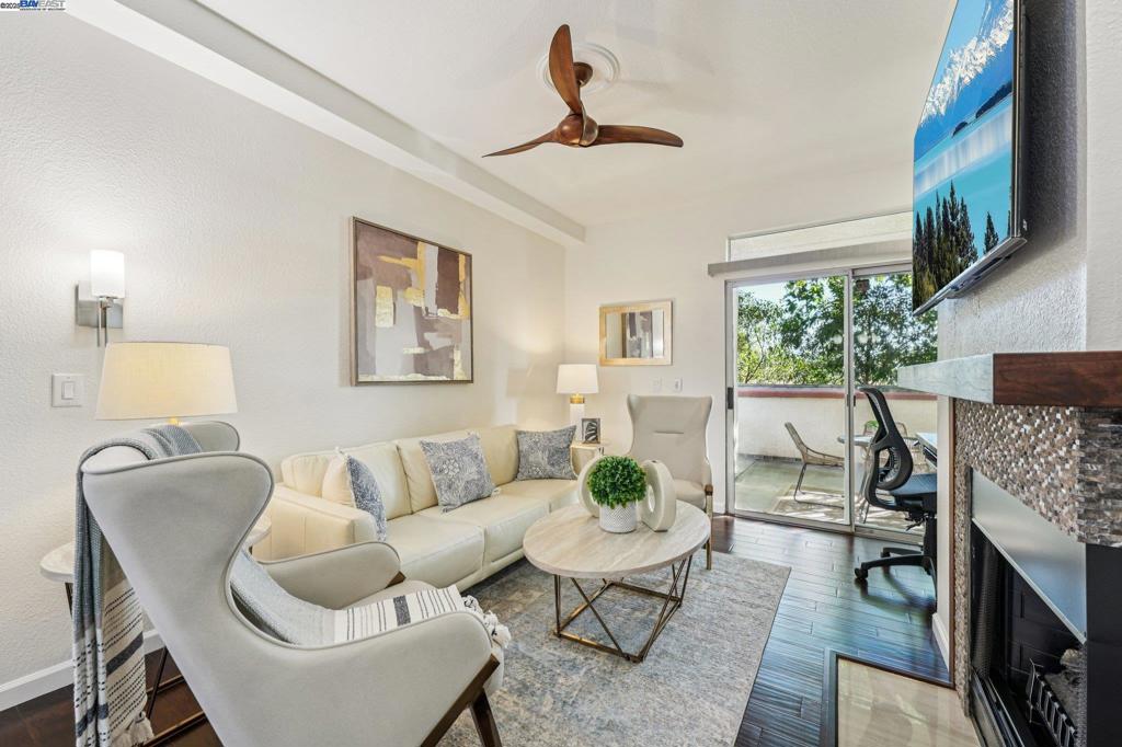 Private and serene, this Mediterranean-style beauty blends comfort with modern flair. Enjoy stunning skyline sunset views from your spacious outdoor patio—perfect for relaxing or entertaining. This desirable lower-level, corner end-unit features wood floors throughout, an open living area, and a beautifully updated kitchen with granite countertops, new cabinetry, and stainless steel appliances. The primary suite boasts a generous walk-in closet, and the convenience of in-unit laundry adds to the ease of everyday living. Includes a dedicated covered end parking stall directly in front of the unit, plus ample guest parking. Prime location within the complex and close proximity to BART, 580/680 freeways, shopping, dining, and local activities. HOA amenities include a clubhouse, BBQ area, volleyball court, and two sparkling swimming pools. A true 10+—don’t miss this opportunity to live in a vibrant and welcoming community! Open house 1 to 4 pm SAT & SUN