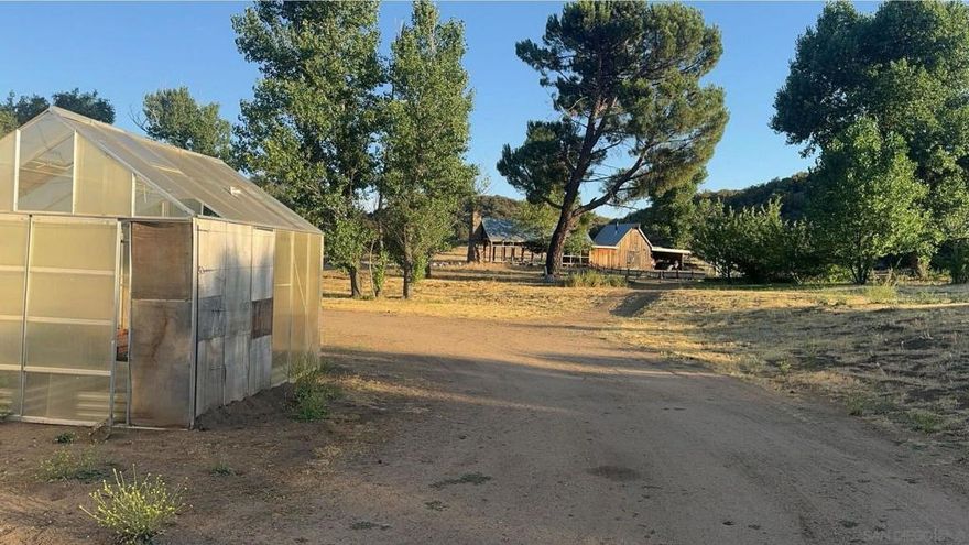 Back on the market at no fault to the seller! Bring your vision and build your dream home on this beautiful peaceful valley, right here in Anza. 2 parcels, totaling 13 acres with paved road access.  There is a homesite with beautiful views, a single wide 14x56 mobile home that is ready for updating, or can be used for storage. A barn and workshop with covered concrete. Party area with its own bath, a stone cabin known as the "cantina", an airstream trailer for guests, and steam railroad traffic covering a football field sized area. This property has been used for movie sets, historical re-enactments, as well as steam powered rail events. Land has great potential for many opportunities to be used for weddings, large family gatherings, with campground, horse ranch or any event you'd like. The water well produces approximately 60 gallons per minute, which is plenty of water for any event. Large commercial septic. Come experience this beauty and bring your offers!