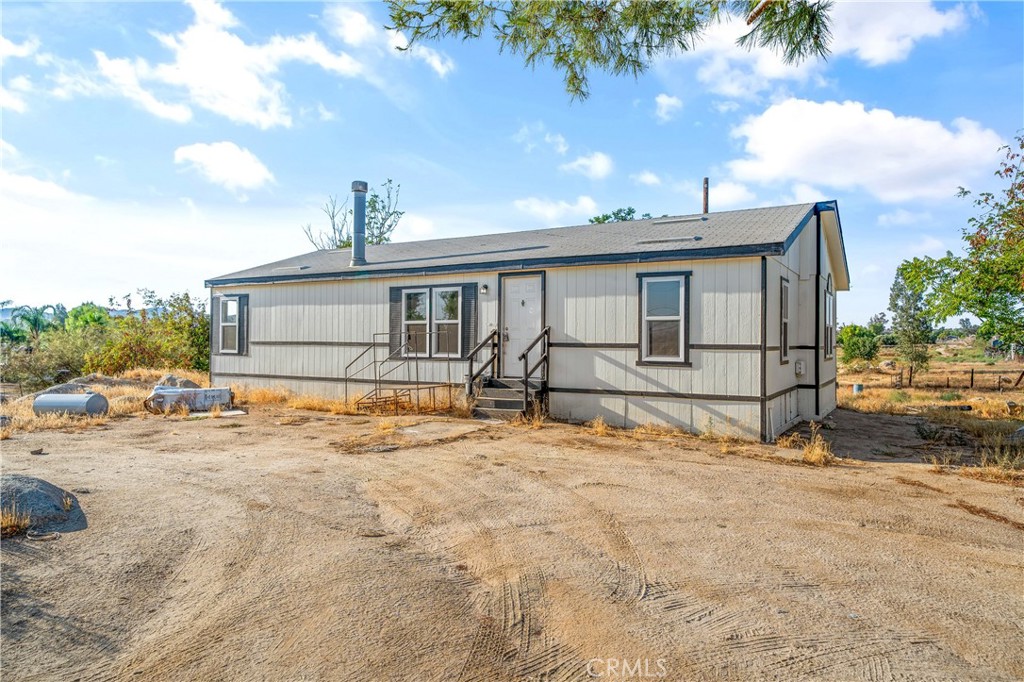 Discover the perfect blend of modern living and wide-open space with this fully remodeled 3 bedroom, 2 bathroom manufactured home in Perris. Nestled on nearly 2.5 acres and located on a paved street for easy access, this turnkey property offers both style and functionality, along with endless possibilities for how the land can be used. This manufactured home has a freshly installed 433 permanent foundation with no space rent and no HOA you own the land!
Inside, you’ll immediately notice the fresh and inviting atmosphere. The kitchen has been completely redesigned with timeless shaker cabinets, elegant quartz countertops, and a full stainless steel appliance package—perfect for cooking and entertaining. The open floor plan flows seamlessly into the living and dining areas, highlighted by new flooring, fresh interior paint, and plenty of natural light streaming through newer dual pane windows. Both bathrooms have been thoughtfully updated with modern finishes, giving the home a clean and contemporary feel throughout.
Step outside and you’ll find nearly 2.5 acres of level, usable land ready to bring your vision to life. Whether you dream of creating a private horse property, starting a garden or orchard, adding a workshop or guest unit, or simply enjoying the peace and privacy that comes with so much space, the opportunities here are endless. The property’s location on a paved street provides the perfect combination of rural charm and convenient access to nearby amenities, shopping, and freeways.
With all the updates completed for you—newer windows, fresh paint, upgraded flooring, remodeled kitchen and bathrooms—this home is truly move-in ready. If you’ve been searching for a modern home with room to grow in a great Perris location, this is the one you’ve been waiting for.