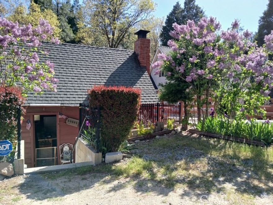Sweetest Lil Cabin in Town. Park your car in front of your cabin and only a few steps down, open your door and relax. 

Crestline has so much to offer, You can walk right in to town for Corks n Hops, Jamboree Days, Fireworks, Shopping all the Local Shops, Post Office, Restaurants and More! The Living room features wood beams on ceiling and a brick fireplace that is open to the space of a simple kitchen. Cozy kitchen features a breakfast counter, Stove, Stacked Washer & Dryer & Refrigerator Garbage Disposal and Water Purifier under the kitchen sink! All appliances are included! There is also a den that can be utilized in so many ways. How about an office, game room, sewing room, a place for your creativity to shine with art, scrapbooks, photo albums or a place for guests to sleep. There is a full bath on this level. The door off the den opens up to the backyard patio. What a great place to relax in your hammock, perfect for gardening, enjoy dinner with friends or neighbors, take a nap or read a book while you listen to the seasonal stream of water that flows from the mountains down to the Lake Gregory. Walk upstairs and you will find a spacious size loft. Plenty of storage and a half bath. There is also a door that opens up to a staircase that leads you down into your backyard.. Looking for your own getaway? We hope to see you soon!!