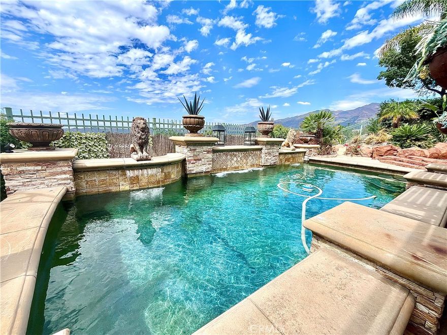 Discover unparalleled Southern California elegance in this exquisite Luxury Pool Estate with breathtaking panoramic vistas in the prestigious 24-hour guard-gated Dove Canyon community. Situated on a prime lot with sweeping, unobstructed scenery, this meticulously enhanced residence features 3 generously sized bedrooms and a versatile bonus room that can seamlessly function as a 4th bedroom, complemented by stunning views, a resort-inspired pool, state-of-the-art solar power system, and the pinnacle of Dove Canyon sophistication. Inside, the upper level includes two bedrooms and two full bathrooms, highlighted by a grand master suite with ample space for a private retreat or home office, paired with a luxurious master bathroom. The main floor hosts one bedroom, a full bathroom, and a flexible space ideal for an office, fitness room, or play area, accentuated by towering vaulted ceilings in the formal living and family areas, a chef’s dream kitchen with top-tier finishes, a spacious center island, and fluid open-concept design, plus a bespoke wine cellar, stone-detailed walls, and elegant designer lighting throughout. The backyard is a resort-quality sanctuary, showcasing a deluxe swimming pool with water features, a secluded grotto-style spa with a cascading waterfall, a custom outdoor fireplace and BBQ area, a vast covered patio for effortless indoor-outdoor gatherings, and meticulously landscaped grounds with panoramic views ensuring complete privacy and tranquility. This eco-conscious estate is equipped with a cutting-edge solar power system, offering sustainable energy efficiency and reduced utility costs. As a resident of one of Orange County’s most coveted luxury enclaves, enjoy access to a Jr. Olympic-sized community pool, tennis and pickleball courts, an exclusive clubhouse with event spaces, miles of picturesque hiking and equestrian trails, and the prestigious Dove Canyon Golf Club. Whether you seek a serene escape, an entertainer’s dream, or a lifelong family home, this extraordinary Luxury Pool Estate with Panoramic Views and Solar Power in Prestigious Dove Canyon embodies the essence of luxury, seclusion, and sustainable Southern California living. Contact us to arrange a private tour of this remarkable property today.