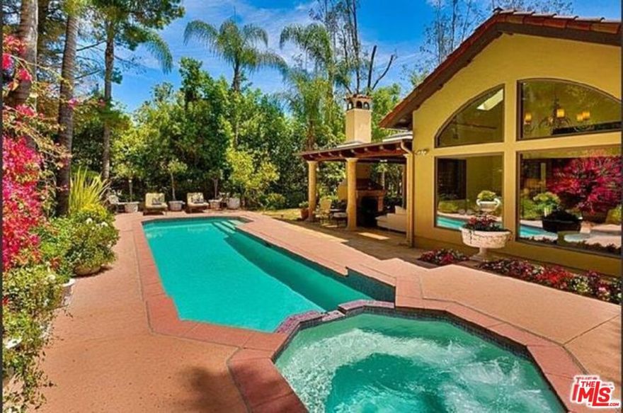 This single-level Mediterranean home is located in the exclusive guard-gated community known as The Summit, atop Beverly Hills. This furnished home offers the finest in quality and design. A two story entry leads to step down living room with vaulted ceilings and fireplace. The state of the art kitchen offers top of the line appliances, granite counters and a large eat-in area. Romantic master bedroom with generous walk-in closet, fireplace, vaulted ceiling and wonderful morning room. All rooms lead out to beautiful gardens, fountains and a totally private pool and spa.