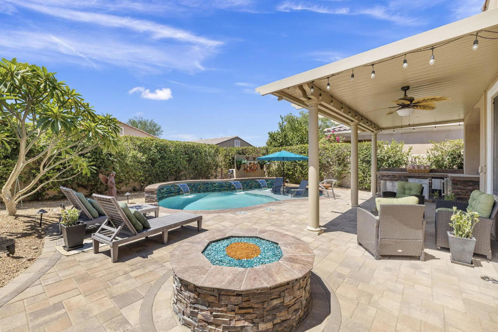 Highly Upgraded and FURNISHED Montoya Model in Sun City Shadow Hills! This beautifully appointed 2-bed, 2-bath home offers a den (featuring an added door for privacy), making the perfect office, bonus room, or even an additional bedroom. Step through the elegant glass front door and onto beautiful light-toned LVP flooring that flows throughout most of the home. Enjoy year-round comfort with a newer A/C unit. The kitchen is a chef's dream with granite countertops, a stylish glass tile backsplash, stainless steel appliances, and pull-out shelving. The living room showcases a dramatic stacked stone accent wall with a custom electric fireplace, adding warmth and sophistication. Custom window coverings and plantation shutters enhance every room. The spacious primary suite offers great separation from the guest bedroom and boasts a walk-in closet, dual vanities, walk-in shower, and a stunning custom wood-paneled accent wall. The guest bathroom features a tiled walk-in shower for a sleek, modern touch. Step outside to your private tropical paradise with a saltwater pool with sheer descents and jets. The outdoor entertainment center includes a refrigerator and ice maker under an Alumawood cover, plus a cozy gas fire pit for relaxing evenings. Additional highlights include a whole-house water filtration and conditioning system plus ample built in cabinets and overhead storage in the garage. Enjoy low HOA dues and a wealth of resort-style amenities, including pools, tennis, pickle ball and bocce ball courts, two golf courses, interest clubs and more. Come experience the best of desert living in this vibrant 55+ community!