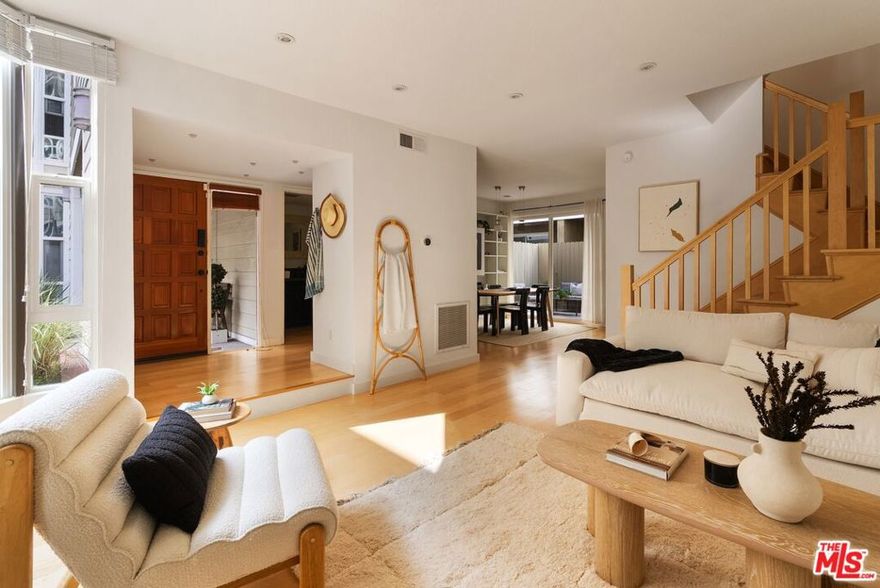 Located in the heart of West Los Angeles' Sawtelle neighborhood, this contemporary townhome combines modern design with everyday livability. The residence offers three bedrooms plus a loft, a private rooftop terrace, and a ground-level patio within one of the area's most desirable gated communities. The main level features maple hardwood floors, an open living and dining area with a sleek decorative fireplace, and a kitchen finished with quartz countertops, stainless-steel appliances, and patio views perfect for entertaining or daily use. A custom built-in bookcase adds storage and character. Upstairs, the primary suite impresses with 20-foot cathedral ceilings, floor-to-ceiling windows, and a spacious en-suite bath. Two additional bedrooms provide flexibility for guests or a home office, while the loft opens to a private rooftop terrace with synthetic turf and sweeping city and mountain views. The private two-car garage includes epoxy flooring, abundant storage, and a large laundry area. Notable updates include full patio waterproofing with designer tile, new maple flooring, a high-efficiency HVAC heat pump with iWave air cleaner, upgraded copper main hot water line, and enhanced lighting and plumbing fixtures. Conveniently located near Sawtelle's restaurants, cafes, and shops, as well as the Metro and major freeways, this home offers a rare blend of privacy, style, and access - ideal for those seeking turnkey living in one of West LA's most connected neighborhoods.