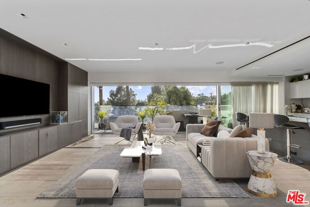 Designer Condo at 838 Doheny. Setting the bar for luxury living in LA. A sophisticated open space, retractable Fleetwood glass doors showcase a wrap around patio for ultimate indoor/outdoor living. An entry leads to open-concept living room, formal dining and chef's kitchen. Custom European cabinets with waterfall countertop, Subzero, Miele, Bosch appliances, creating a perfect layout for entertaining. The living area with surround sound Sonos system, motorized solar shades, Lutton lighting controls, Nest and air filtration system. The two-bed unit features a primary with ensuite bath a dual vanity, soaking tub, glassed shower, heated floors, walk-in closet and extra storage. A guest room and 2nd bath complete. Wide-plank Oak floors throughout, new electrical and plumbing systems, private laundry with pantry area. Building amenities: a roof-top pool with sundecks and dining areas, fire-pits, gym and 360 degree views from city to ocean. A 2nd pool, full time concierge and valet. Cable, internet, HBO, and water included.